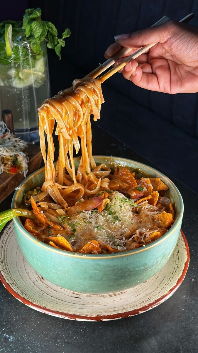 Noodles being lifted from a ramen bowl at EMC Kitchen